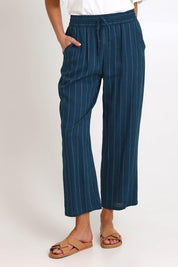 Model Madelinec wearing size 10 of the Palm Relax Pants – Teal in colour Teal, in a cropped view