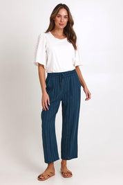 Model Madelinec wearing size 10 of the Palm Relax Pants – Teal in colour Teal, from the front