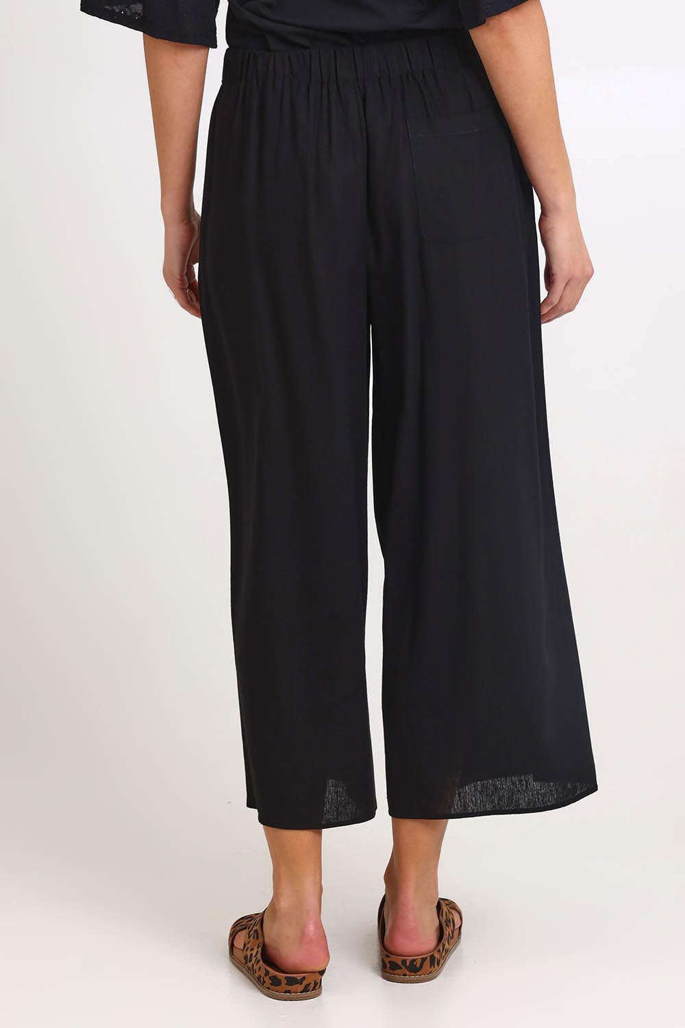 Model Madelinec wearing size 10 of the Bella Crop Pants – Black in colour Black, from the back