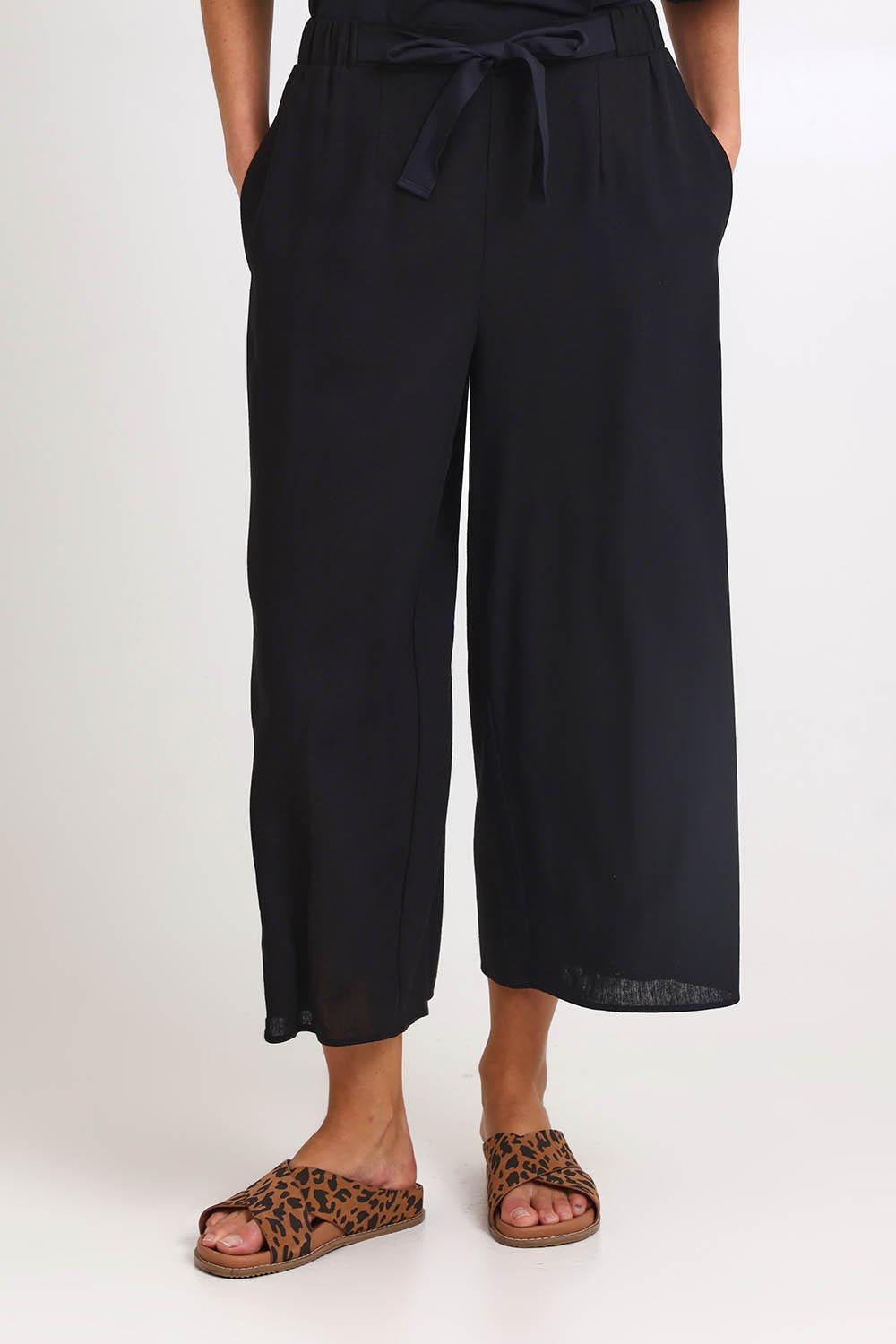 Model Madelinec wearing size 10 of the Bella Crop Pants – Black in colour Black, in a cropped view