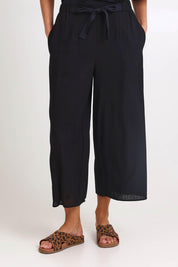 Model Madelinec wearing size 10 of the Bella Crop Pants – Black in colour Black, in a cropped view