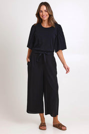 Model Madelinec wearing size 10 of the Bella Crop Pants – Black in colour Black, from the front