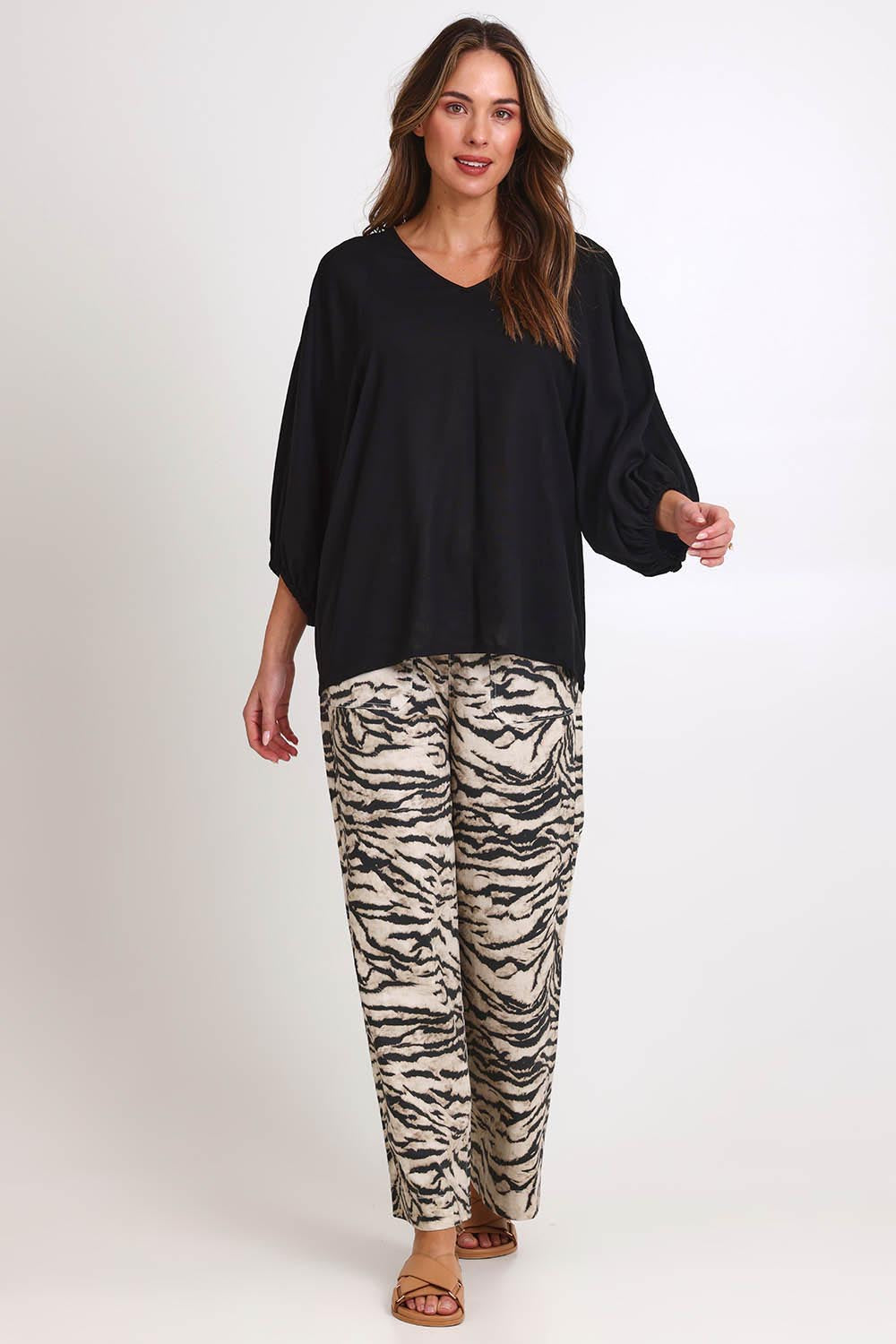 Model Madelinec wearing size 10 of the Bella Blouse – Black in colour Black, from the front