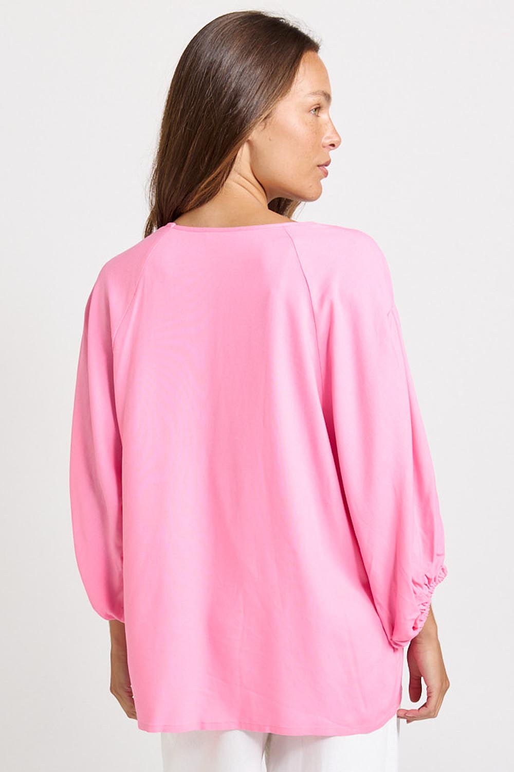 Model Genericm wearing size sample of the Bella Blouse – Pink in colour Pink, from the back