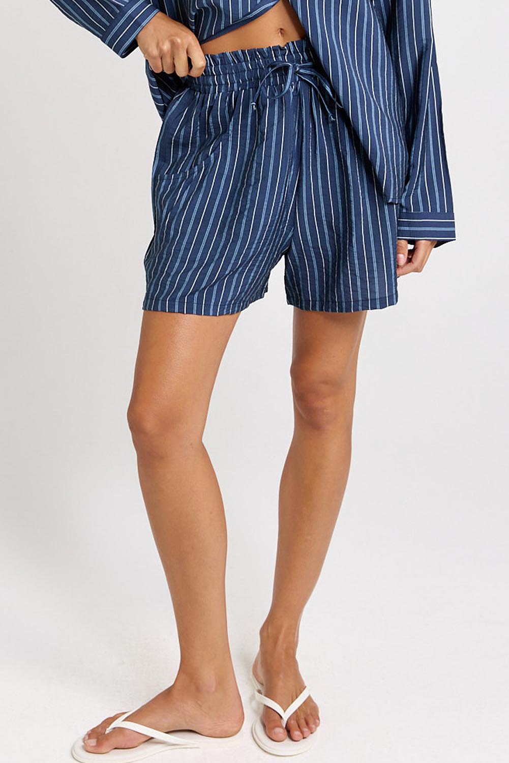 Model Genericm wearing size sample of the Sorrento Short – Blue in colour Blue, from an angle