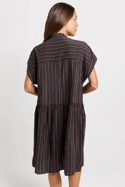Model Genericm wearing size sample of the Sandy Dress – Brown in colour Brown, from the back