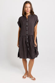 Model Genericm wearing size sample of the Sandy Dress – Brown in colour Brown, from the front