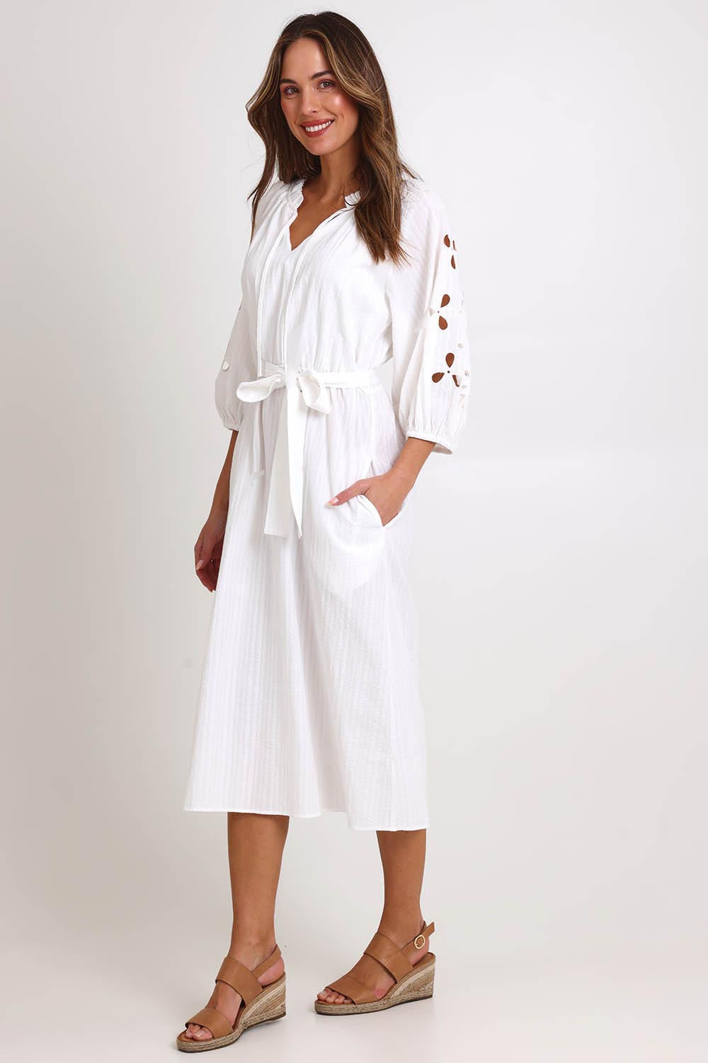 Model Madelinec wearing size 10 of the Nia Dress – White in colour White, from the front