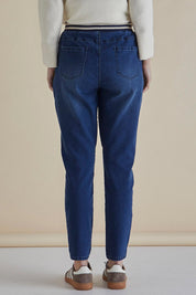 A model wearing the Dakota Denim Pant in colour Bayblue (Blue), from the back