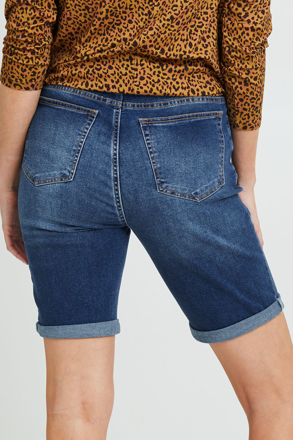 Model Grace wearing size 10 of the Bonnie Bermuda Denim in colour Indigo (Blue), from the back