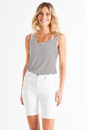 A model wearing the Bonnie Bermuda Denim Short in colour White (White), from the front, cropped image