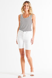 A model wearing the Bonnie Bermuda Denim Short in colour White (White), from the front, showing the whole outfit