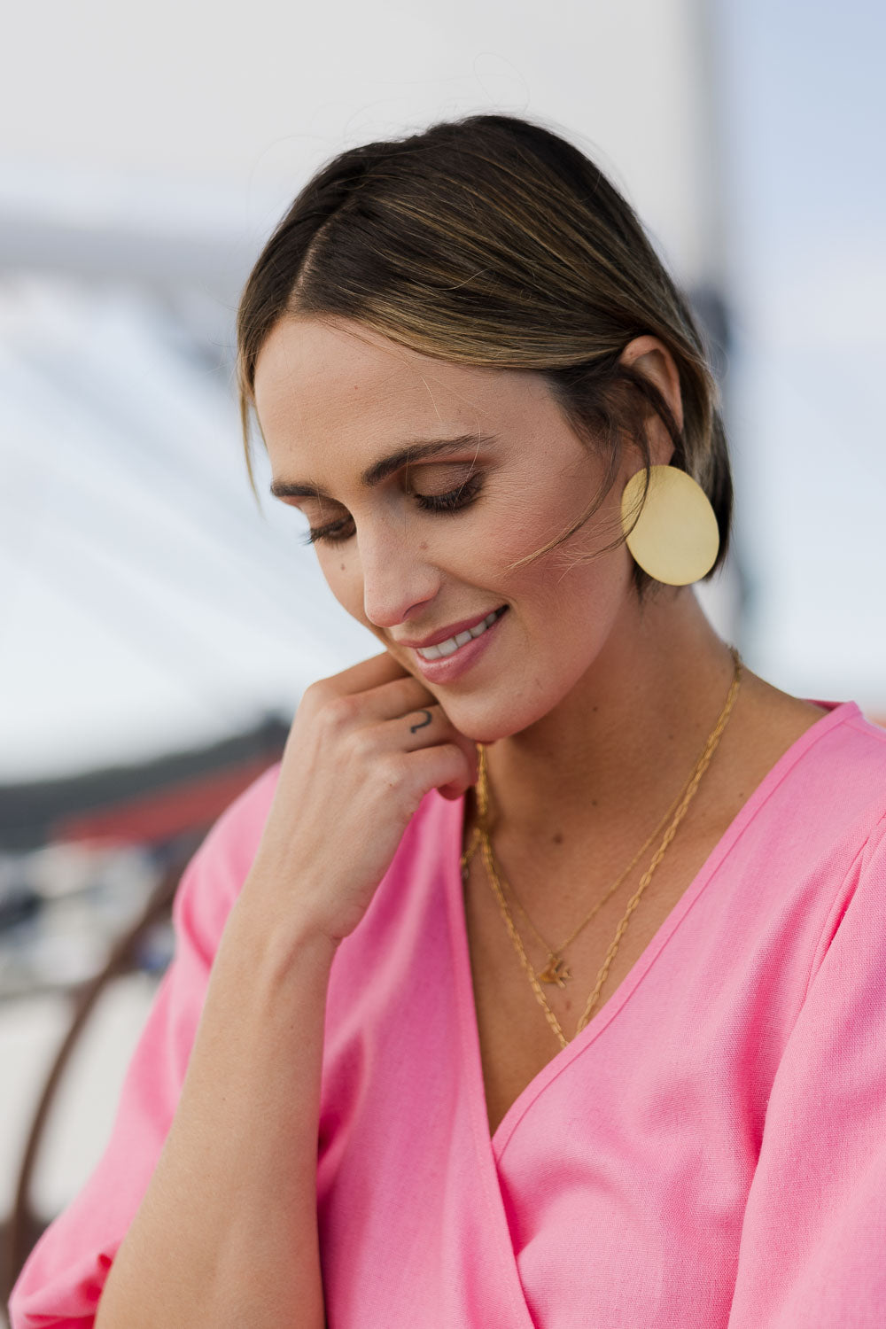 Model Tegan wearing size OneSize of the Brass Flat Oval Earrings in colour Goldbrass (Metallics), from the front, showing the whole outfit
