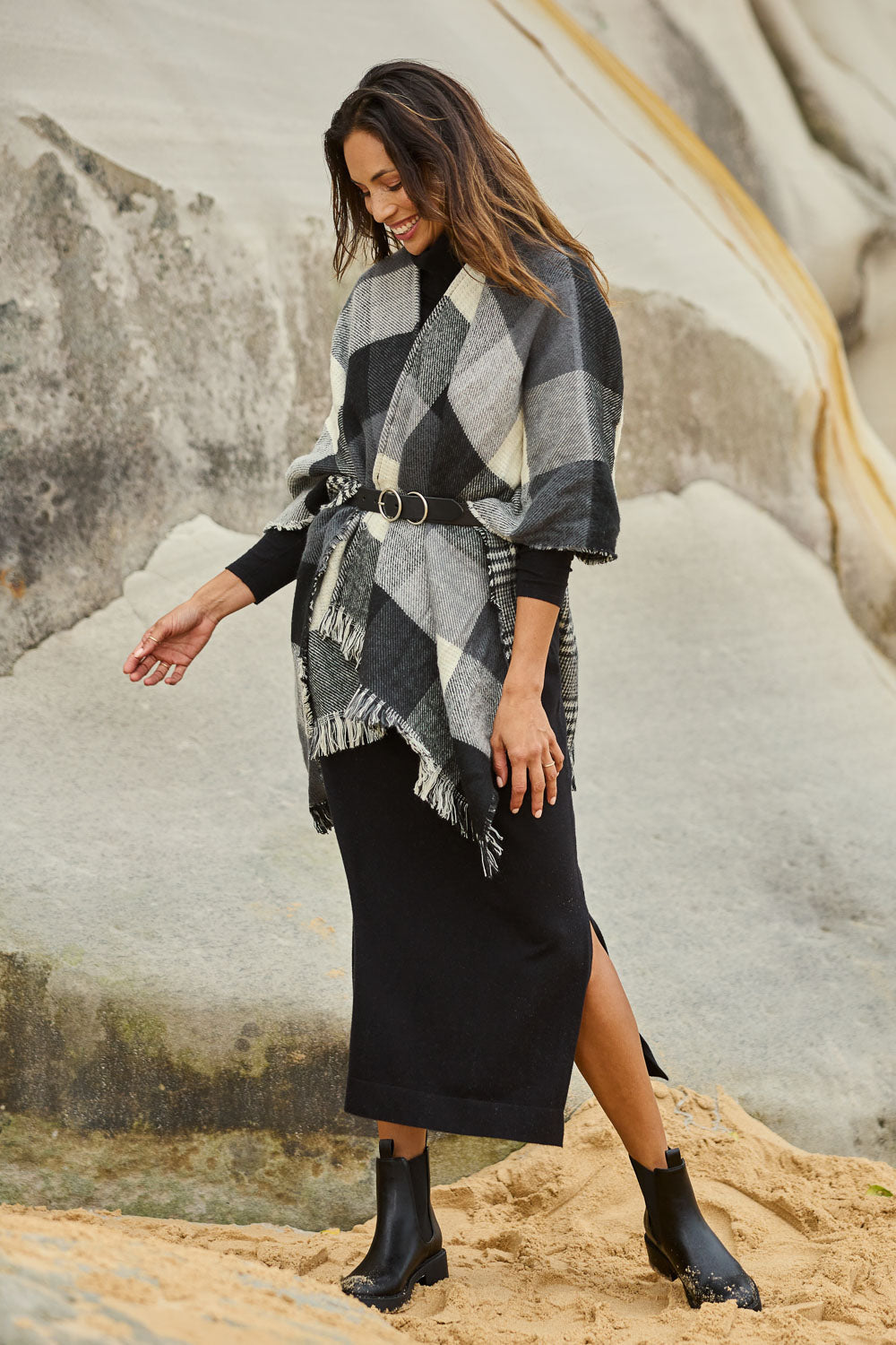 Model Amanda wearing size OneSize of The Keepers Check Cape in colour Blackivory (Black), from the front, showing the whole outfit