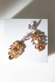 A model wearing size OneSize of the Glass Cluster Earrings in colour Champagne, from the front, showing the whole outfit