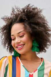 Model Olivia wearing size OneSize of the Bunch of Colour Earrings in colour Green (Green), from the front, showing the whole outfit