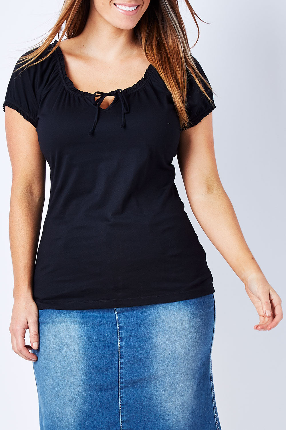Model Laura wearing size 12 of The Everyday Tee in colour JetBlack (Black), from the front, cropped image