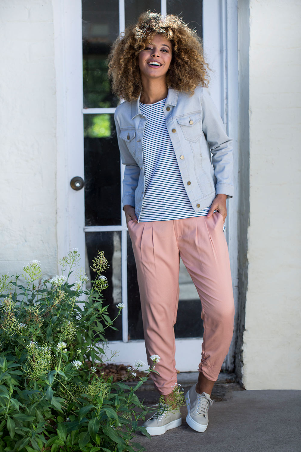 Model Summer wearing size 10 of The Best Seller Pant in colour Clay (Pink), from the front, showing the whole outfit