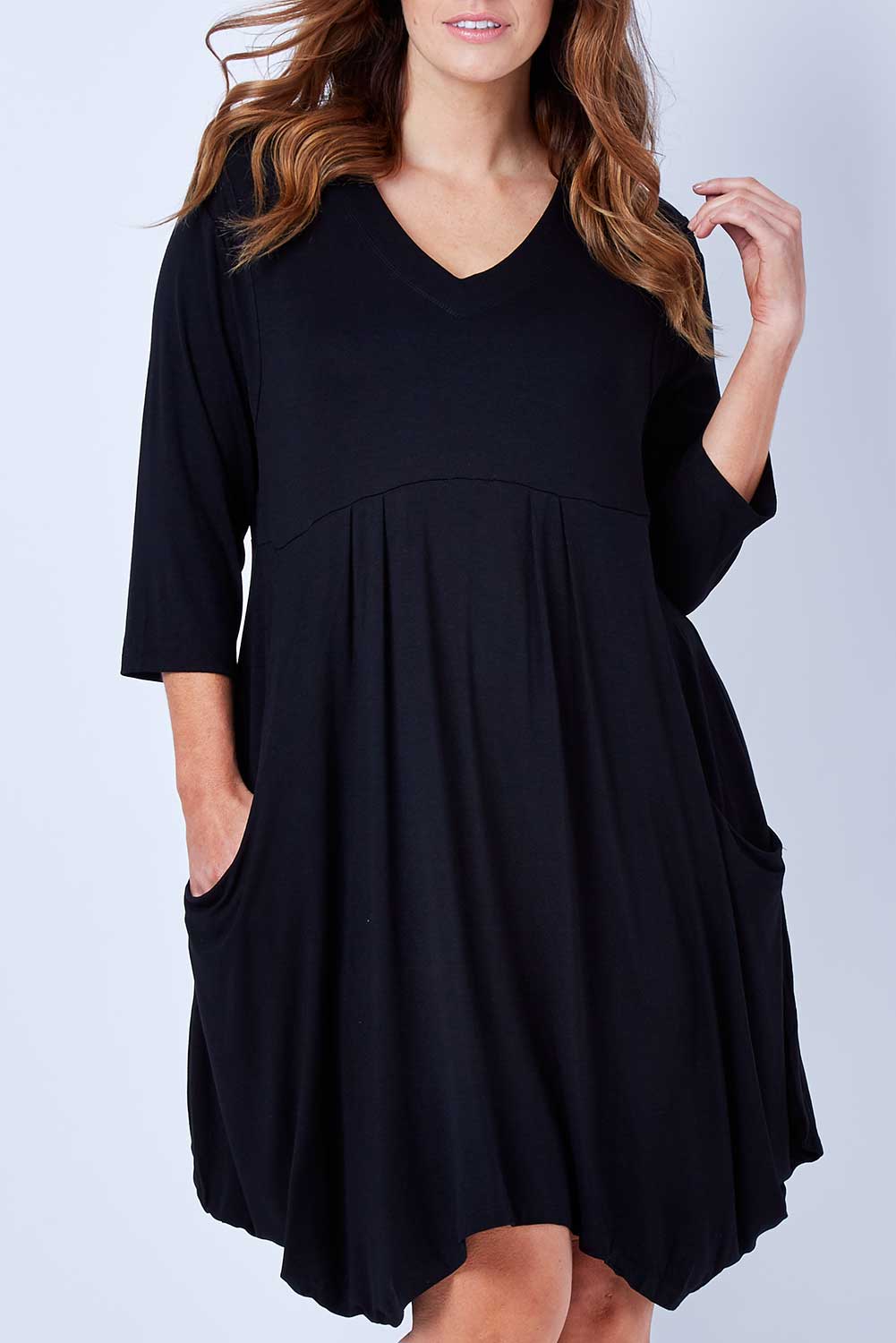 Model Laura wearing size 12 of The Pocket Tunic Dress in colour Black (Black), from the front, cropped image