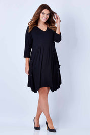 Model Laura wearing size 12 of The Pocket Tunic Dress in colour Black (Black), from the front, showing the whole outfit