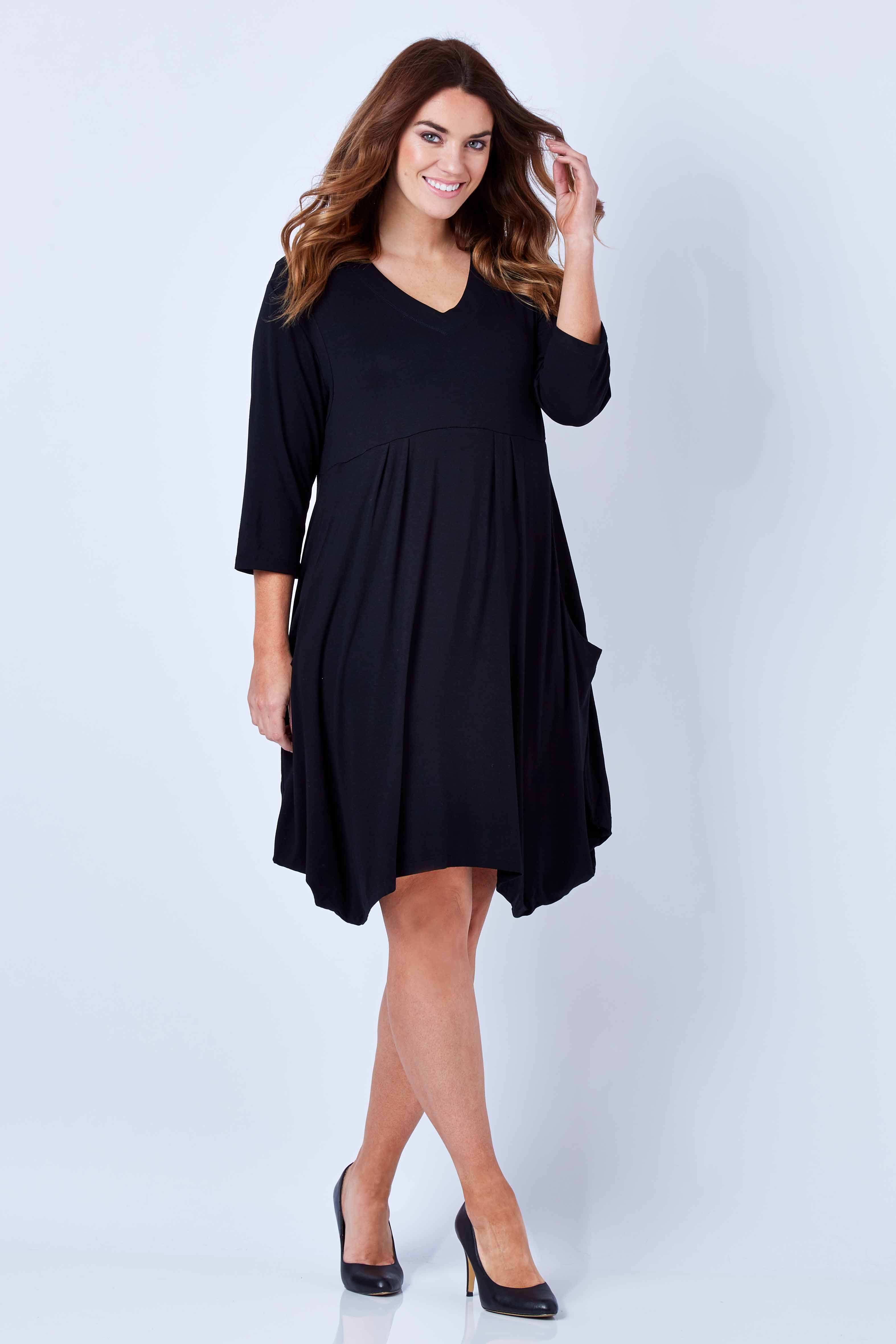 Model Laura wearing size 12 of The Pocket Tunic Dress in colour Black (Black), from the front, showing the whole outfit