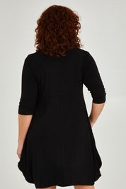 Model Maddy wearing size 16 of The Pocket Tunic Dress in colour Black (Black), from the back