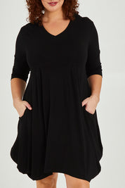 Model Maddy wearing size 16 of The Pocket Tunic Dress in colour Black (Black), from the front, cropped image
