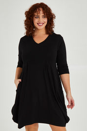 Model Maddy wearing size 16 of The Pocket Tunic Dress in colour Black (Black), from the front, cropped image