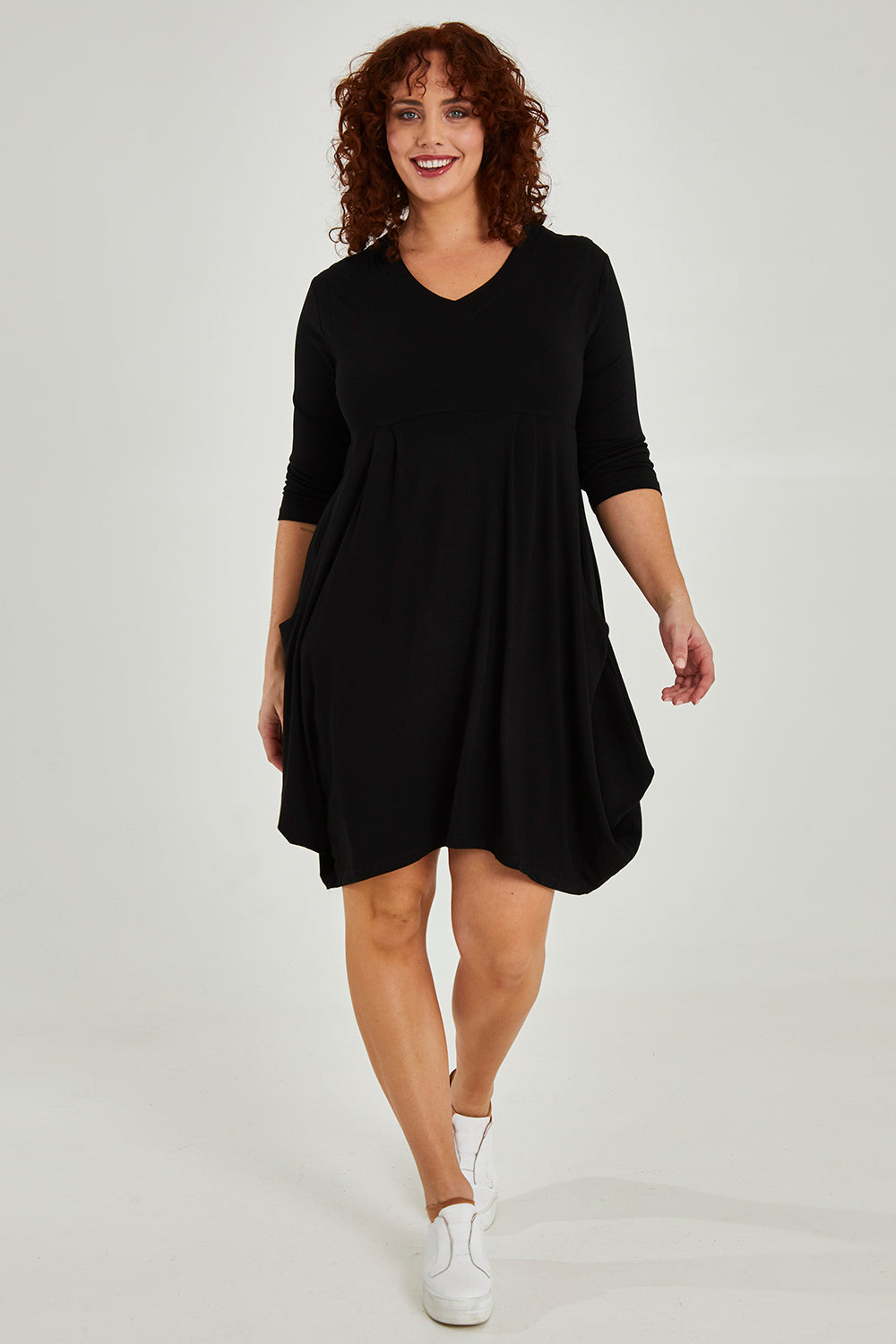 Model Maddy wearing size 16 of The Pocket Tunic Dress in colour Black (Black), from the front, showing the whole outfit
