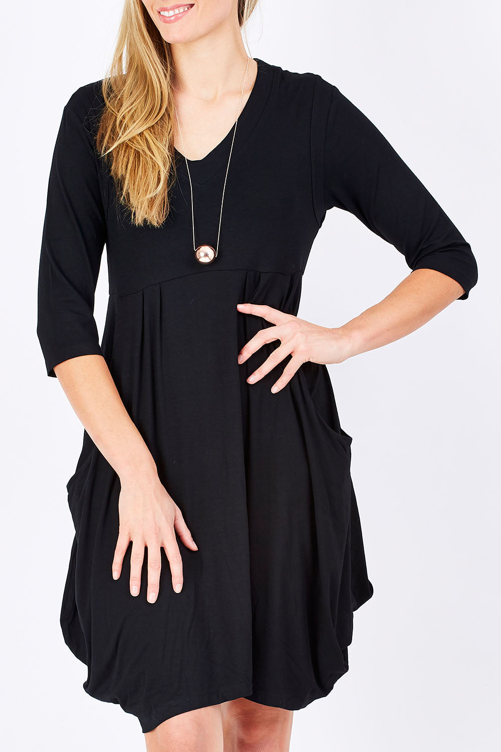 Model Maddy wearing size 10 of The Pocket Tunic Dress in colour Black (Black), from the front, cropped image