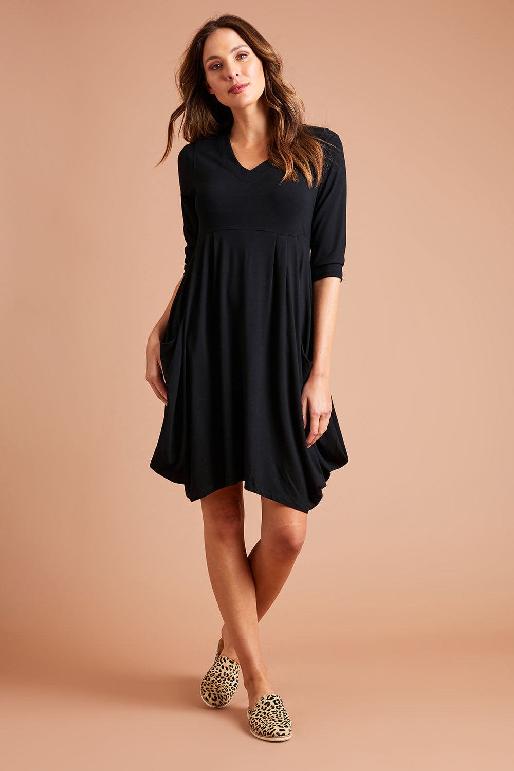 Model Madeline wearing size 10 of The Pocket Tunic Dress in colour Black (Black), from the front, showing the whole outfit