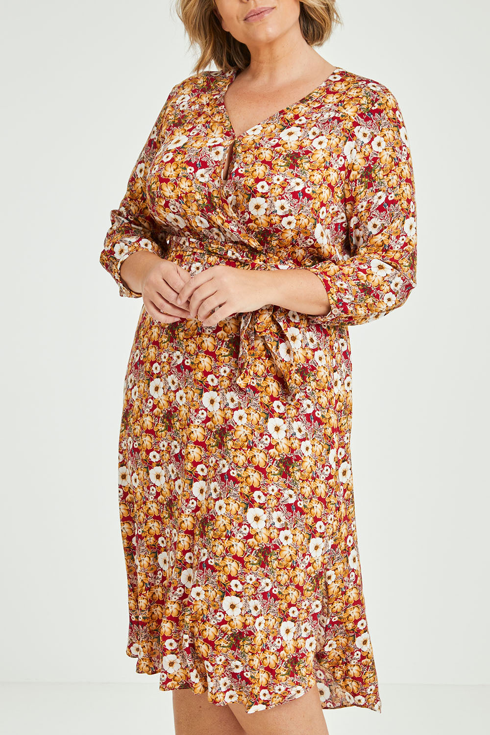 Model Fiona wearing size 16 of The Wrap Front Midi Dress in colour Redfloral (Red), from the front, cropped image