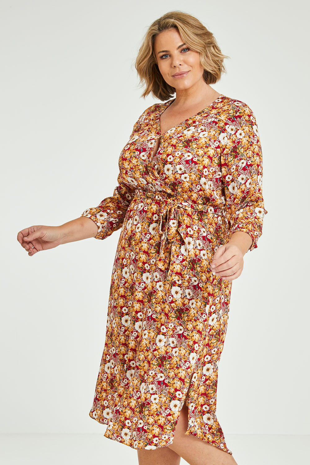Model Fiona wearing size 16 of The Wrap Front Midi Dress in colour Redfloral (Red), from the front, cropped image