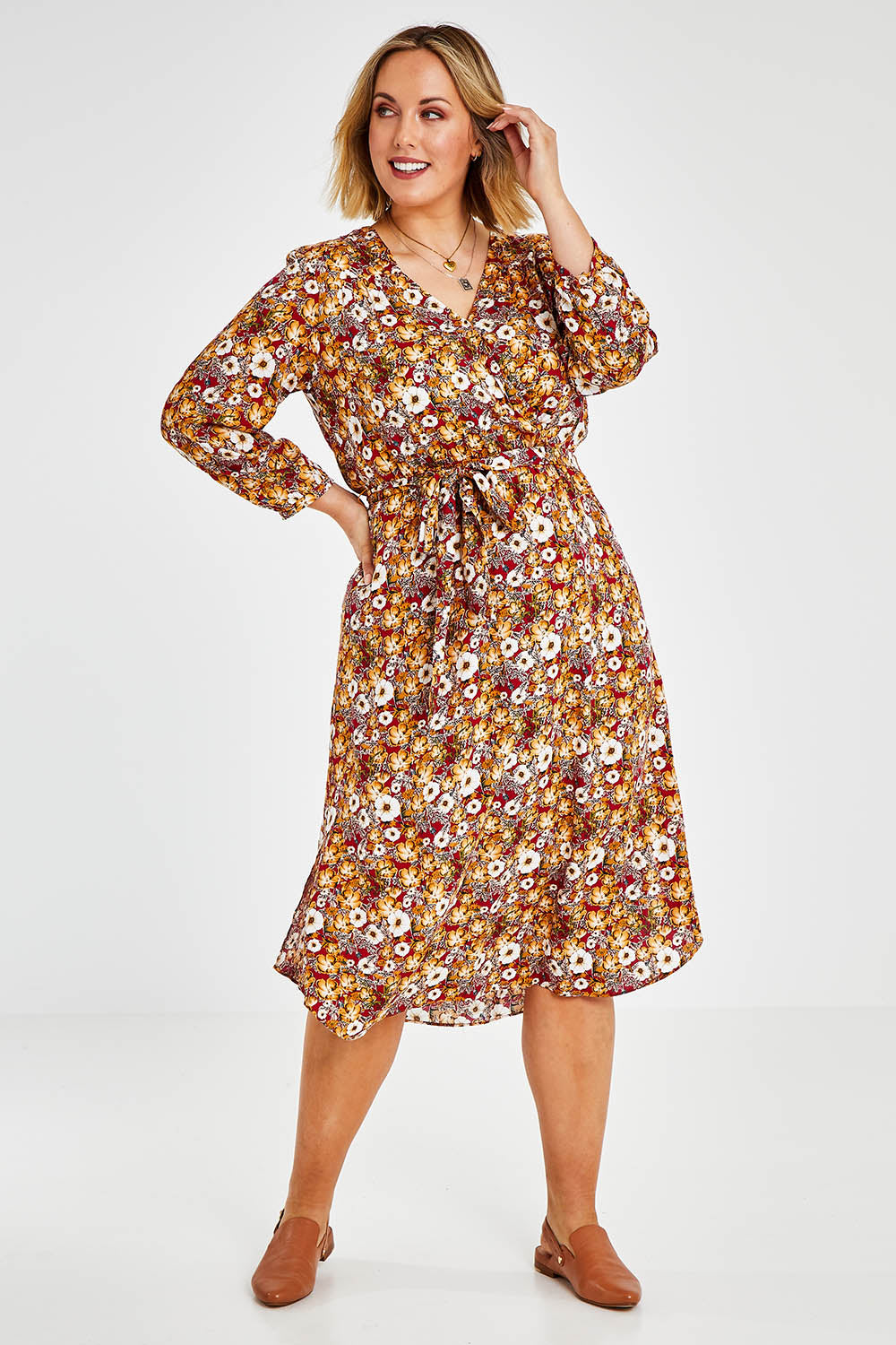 Model Jess wearing size 14 of The Wrap Front Midi Dress in colour Redfloral (Red), from the front, showing the whole outfit