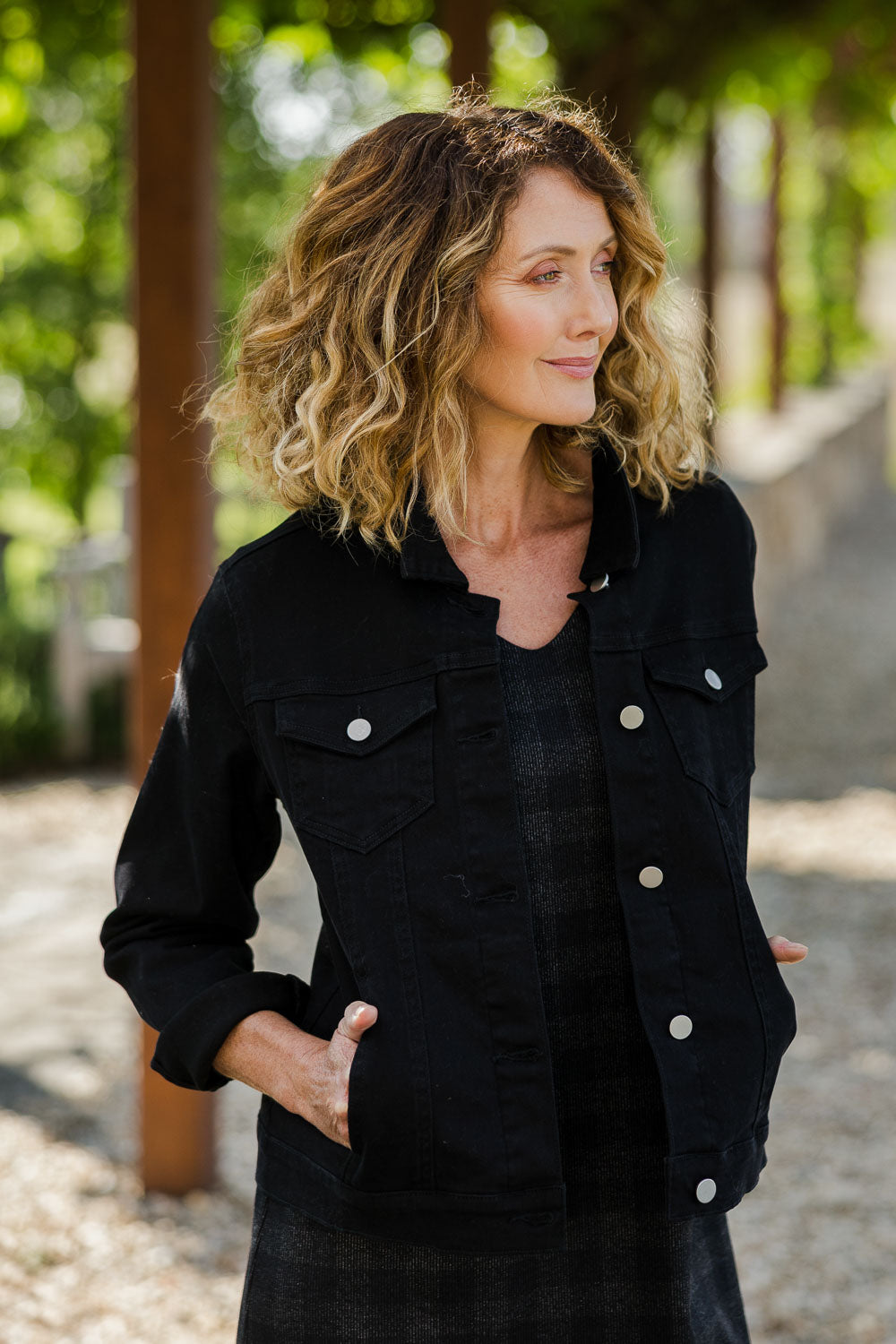 Model Emma wearing size 10 of The Denim Jacket in colour Black (Black), from the front, showing the whole outfit
