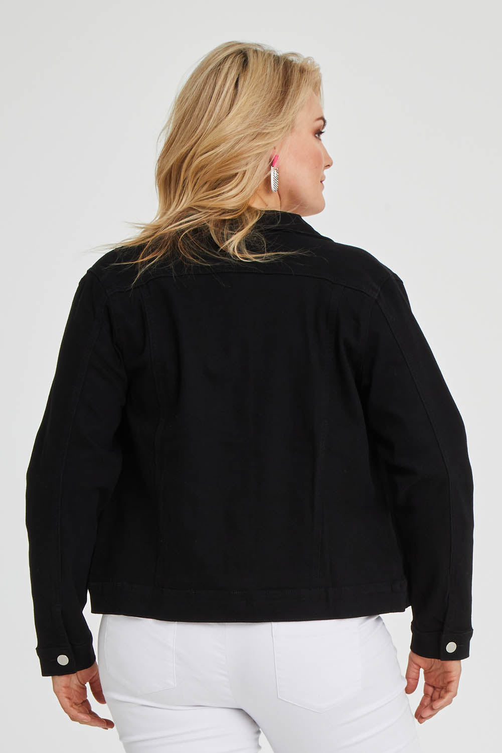 Model Keeara wearing size 16 of The Denim Jacket in colour Black (Black), from the back