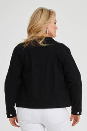 Model Keeara wearing size 16 of The Denim Jacket in colour Black (Black), from the back