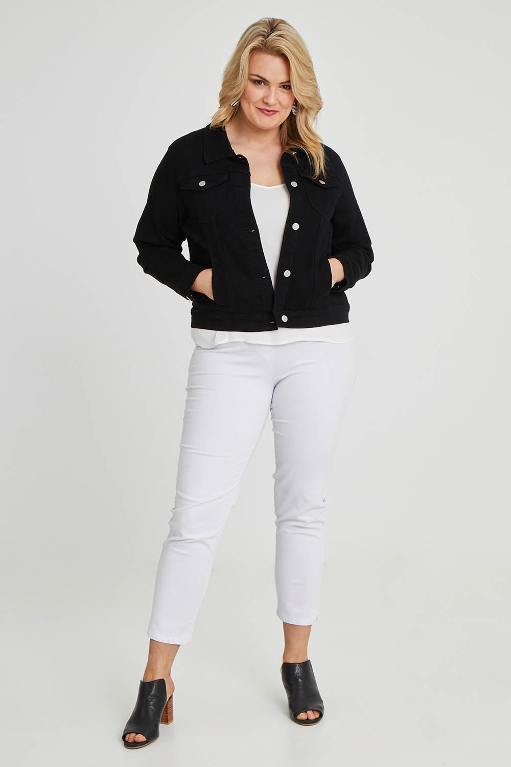 Model Keeara wearing size 16 of The Denim Jacket in colour Black (Black), from the front, showing the whole outfit