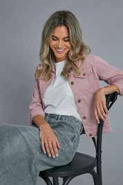 Model Alice wearing size 10 of The Denim Jacket in colour Dustypink (Pink), from the front, cropped image