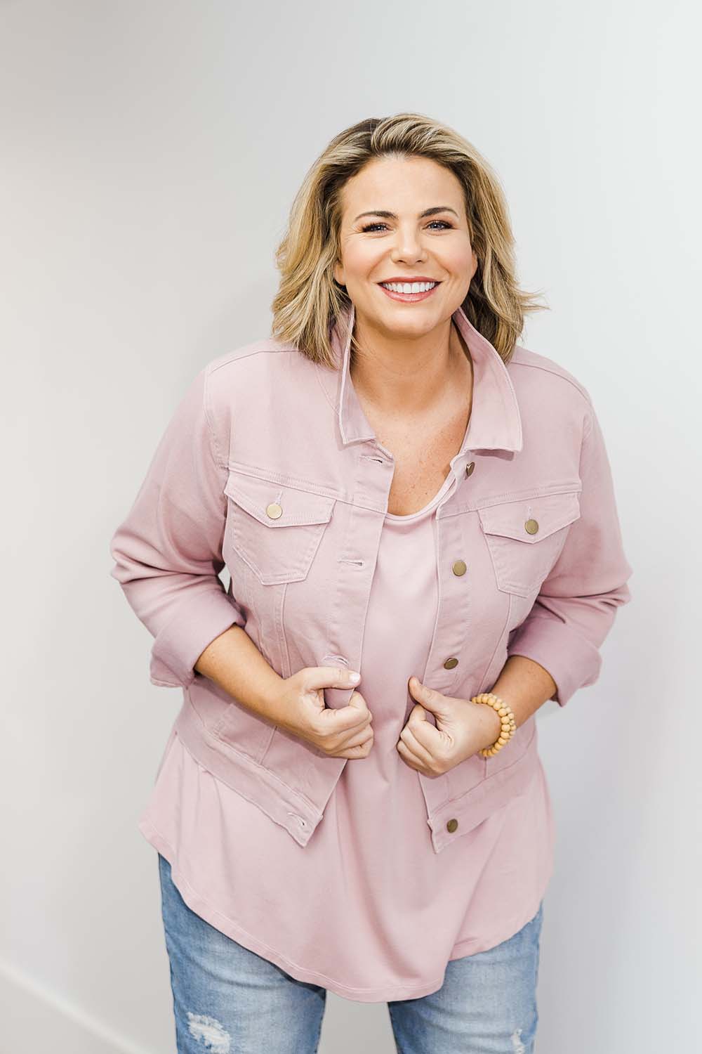 Model Fiona wearing size 16 of The Denim Jacket in colour Dustypink (Pink), from the front, showing the whole outfit