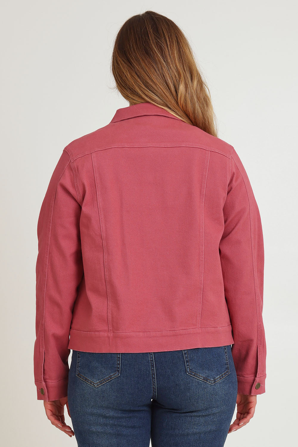 Model Chanel wearing size 16 of The Denim Jacket in colour Smokeyrose (Pink), from the back