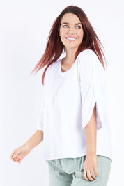 Model Laura wearing size 14 of The Split Sleeve Tee in colour White (White), from the front, cropped image