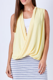 Model Anna wearing size 10 of The Sleeveless Cross Over Blouse in colour Sunshine, from the front, cropped image