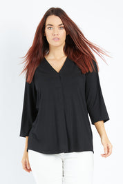 Model Laura wearing size 14 of The Stitch Detail Top in colour Black (Black), from the front, cropped image