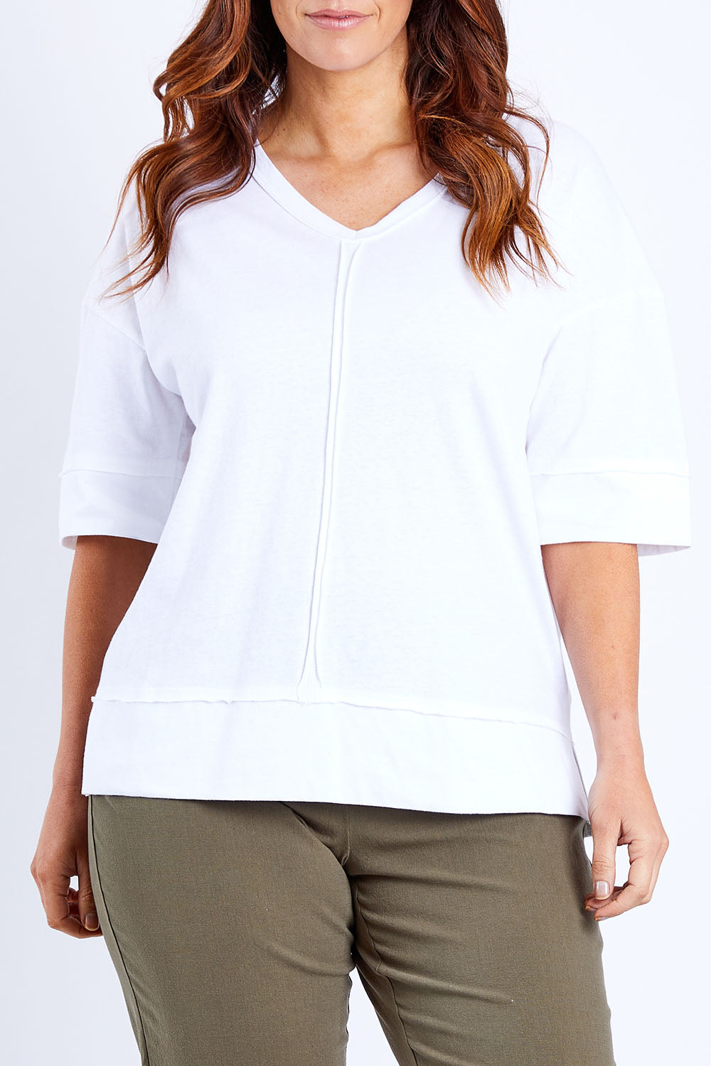Model Laura wearing size 14 of The Panel Detail Tee in colour White (White), from the front, cropped image