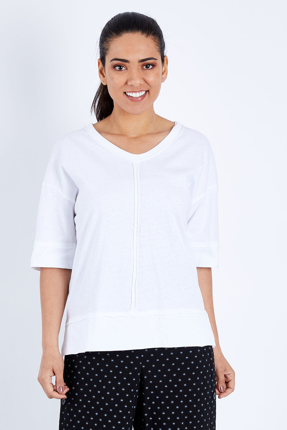 Model Pamela wearing size 10 of The Panel Detail Tee in colour White (White), from the front, cropped image
