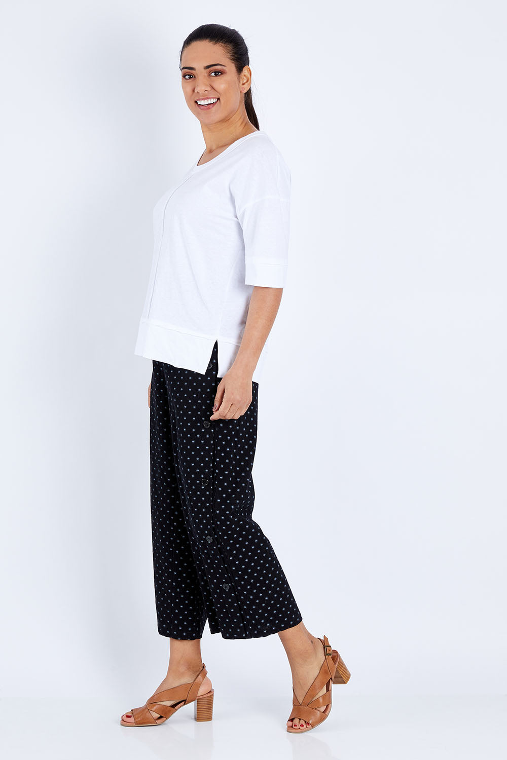 Model Pamela wearing size 10 of The Panel Detail Tee in colour White (White), from the front, showing the whole outfit