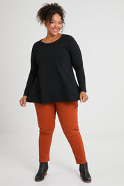 Model Alexis wearing size 16 of The Long Sleeve Swing Tee in colour Black (Black), from the front, showing the whole outfit