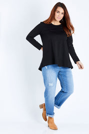 Model Laura wearing size 12 of The Long Sleeve Swing Tee in colour Black (Black), from the front, showing the whole outfit