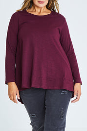 Model Palatina wearing size 16 of The Long Sleeve Swing Tee in colour Shiraz (Red), from the front, cropped image